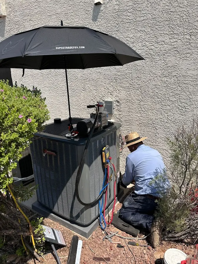 HVAC technician performing outdoor AC maintenance in Cambridge